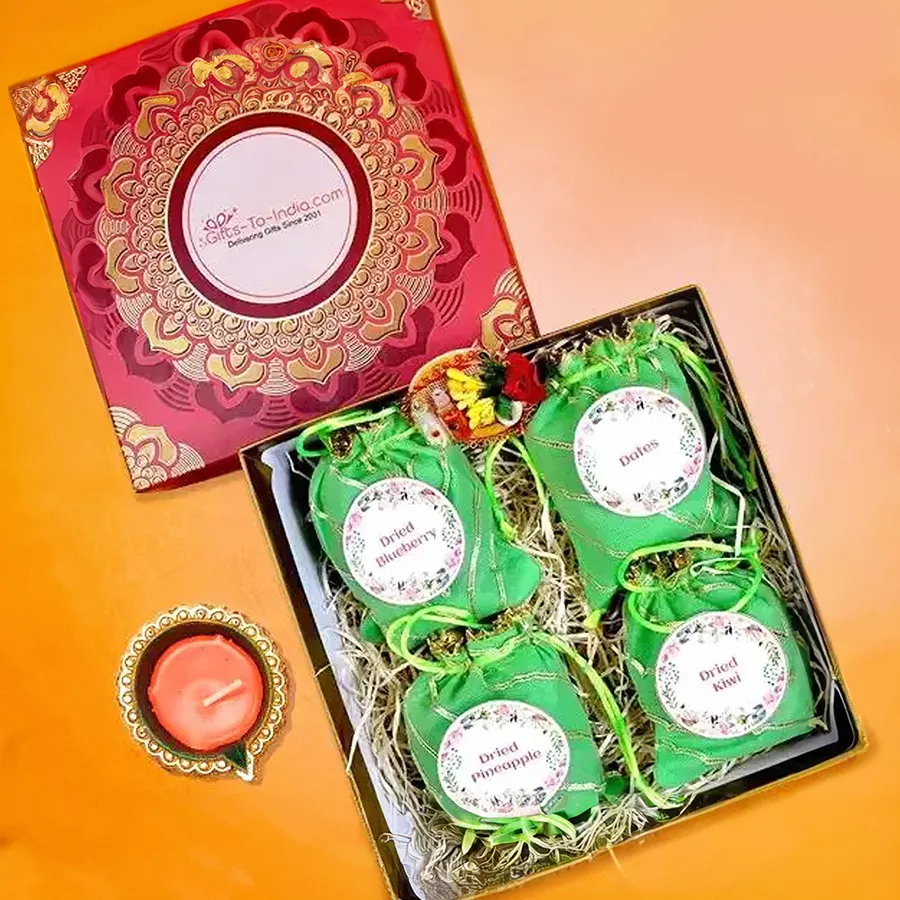 Diwali Dried Fruit Medley hamper featuring a Diya lamp and a mix of dried kiwi, pineapple, dates, and blueberries.