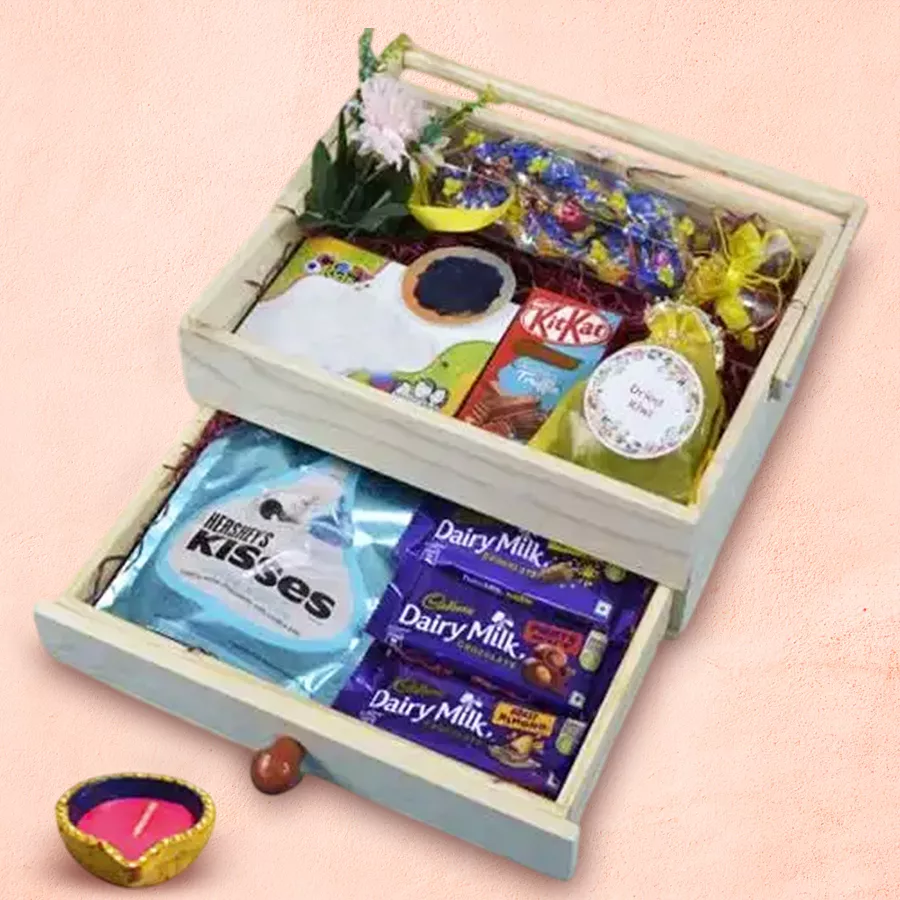 Diwali Chocs and Diya Hamper featuring Dairy Milk chocolates, handmade toffee shapes, Hershey's Kisses, dried kiwi, and a decorative diya
