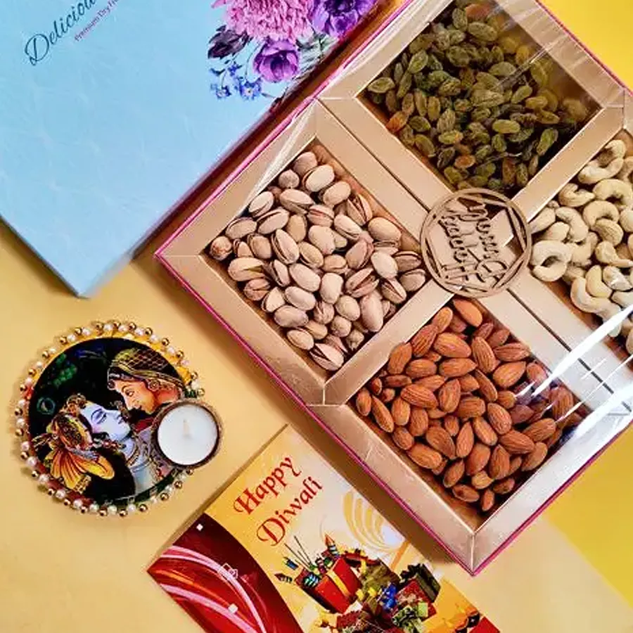 Nutty Surprise gift box featuring premium cashews, almonds, pistachios, sweet raisins, and a designer T-light candle set, presented elegantly for Diwali celebrations.