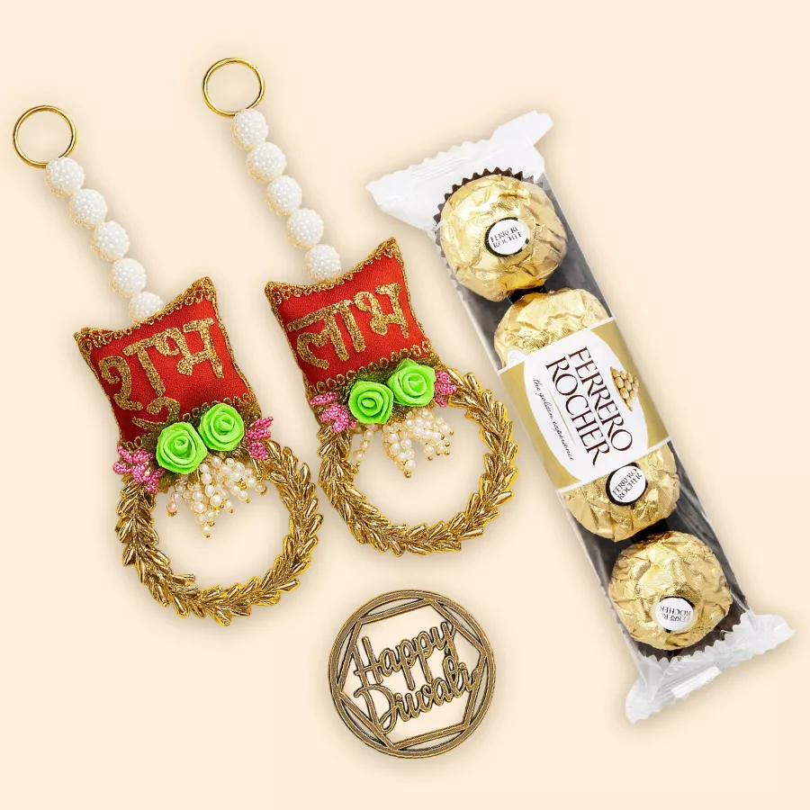 Gift set featuring four Ferrero Rocher chocolates and two Shubh Laabh artisanal hangings on a decorative background.