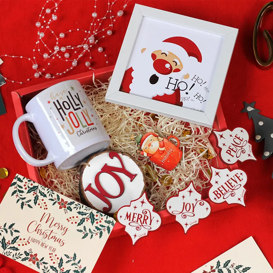 Magical Christmas Surprises Gift Set featuring a cozy mug, charming postcard, quirky sliced log, four colorful tree ornaments, and a festive fridge magnet.