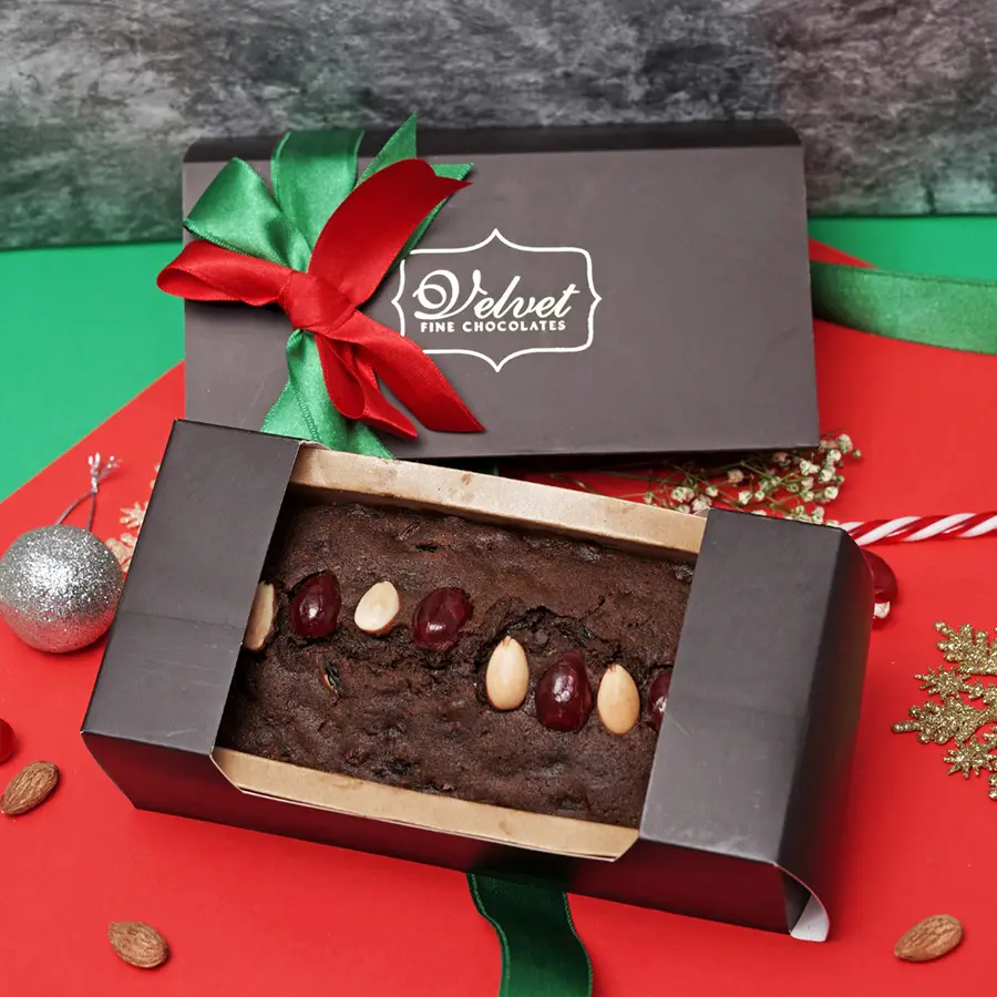 Irresistible Plum Cake Delicacy packaged in an elegant box with rich, fruity flavors and festive decorations
