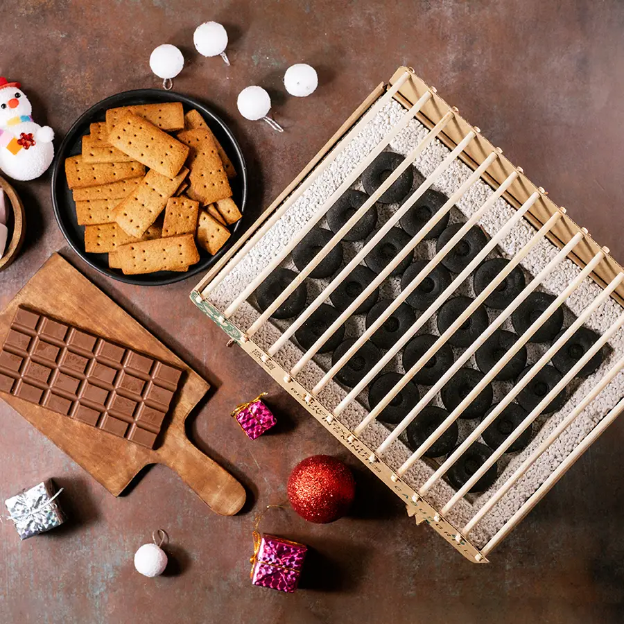DIY S'mores Kit and Grill Combo with marshmallows, crackers, chocolates, and grill set up for making s'mores.