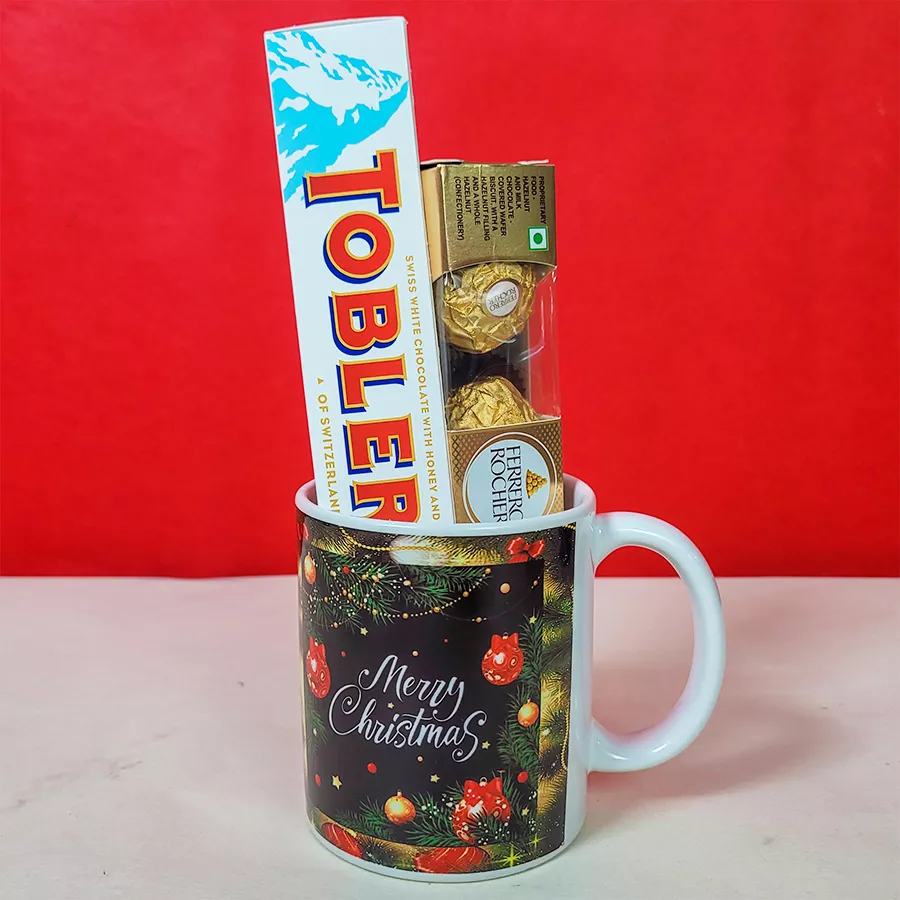 Delectable Chocolates and Christmas Mug Combo featuring a festive mug, Ferrero Rocher chocolates, and a Toblerone White Chocolate bar