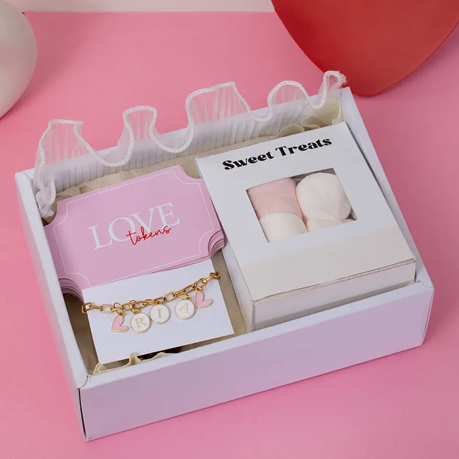 Delightful Love Gifts Surprises hamper featuring Love Tokens, a Marshmallow Pack, and a Personalized Initial Alphabet Bracelet in a sleek Slider Box.