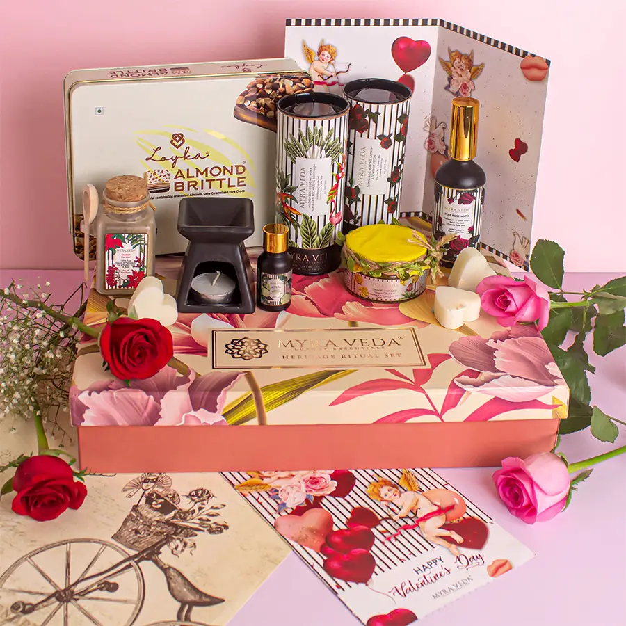 Myra Vedas Love N Luxury Gift Hamper with essential oil, diffuser, tea light candle, almond chocolates, body care products, gold gel, clay, and handwritten card.
