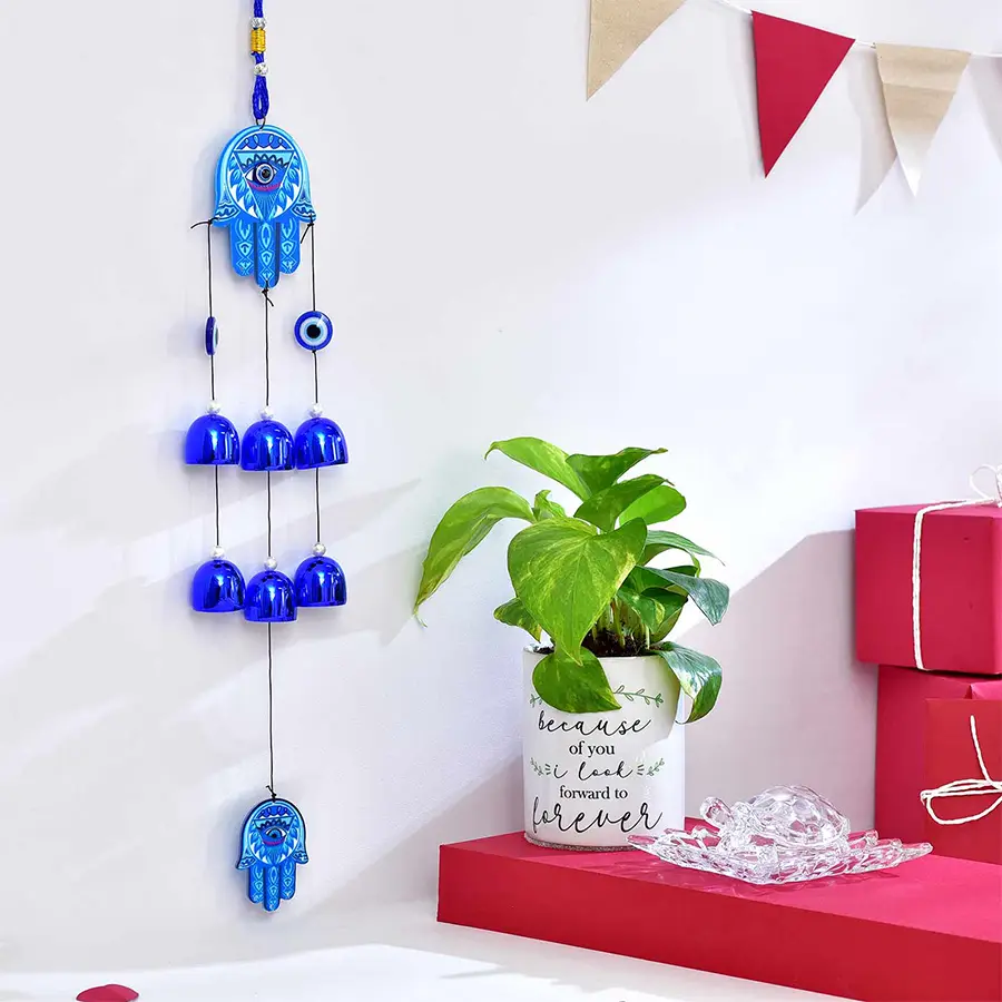 Feng Shui Serenity Hamper featuring a Money Plant, Feng Shui Crystal Tortoise, and Evil Eye Wind Chime on a stylish plate