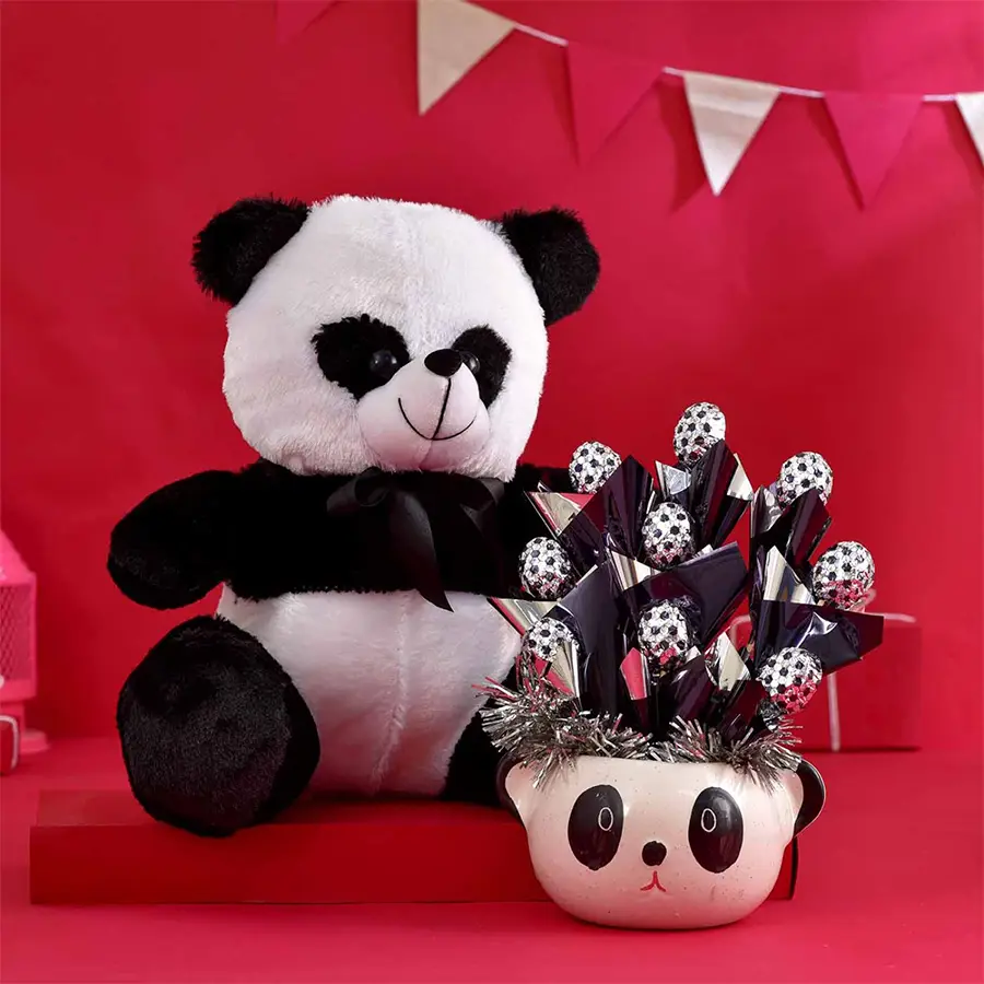 Whimsical Valentine's gift arrangement featuring handcrafted chocolates, a ceramic panda planter, and a 12-inch panda soft toy.