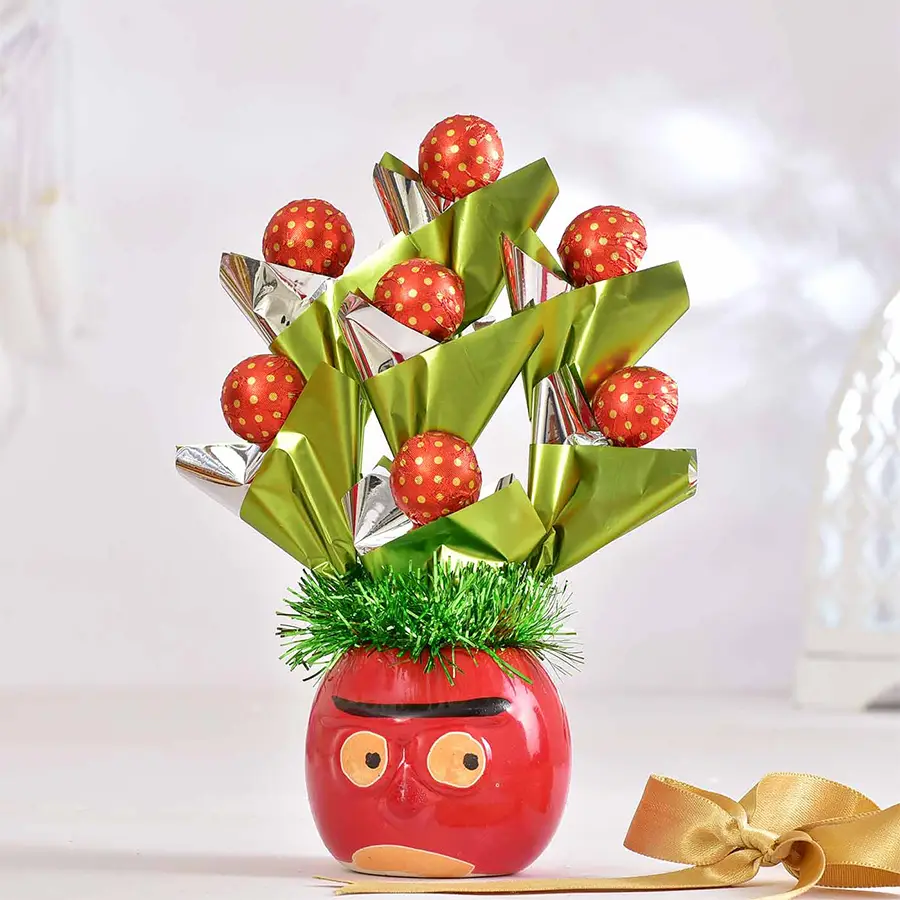 A vibrant red ceramic pot filled with seven handcrafted chocolates, accompanied by a sweet Valentine’s Day card, arranged elegantly for a romantic gift.