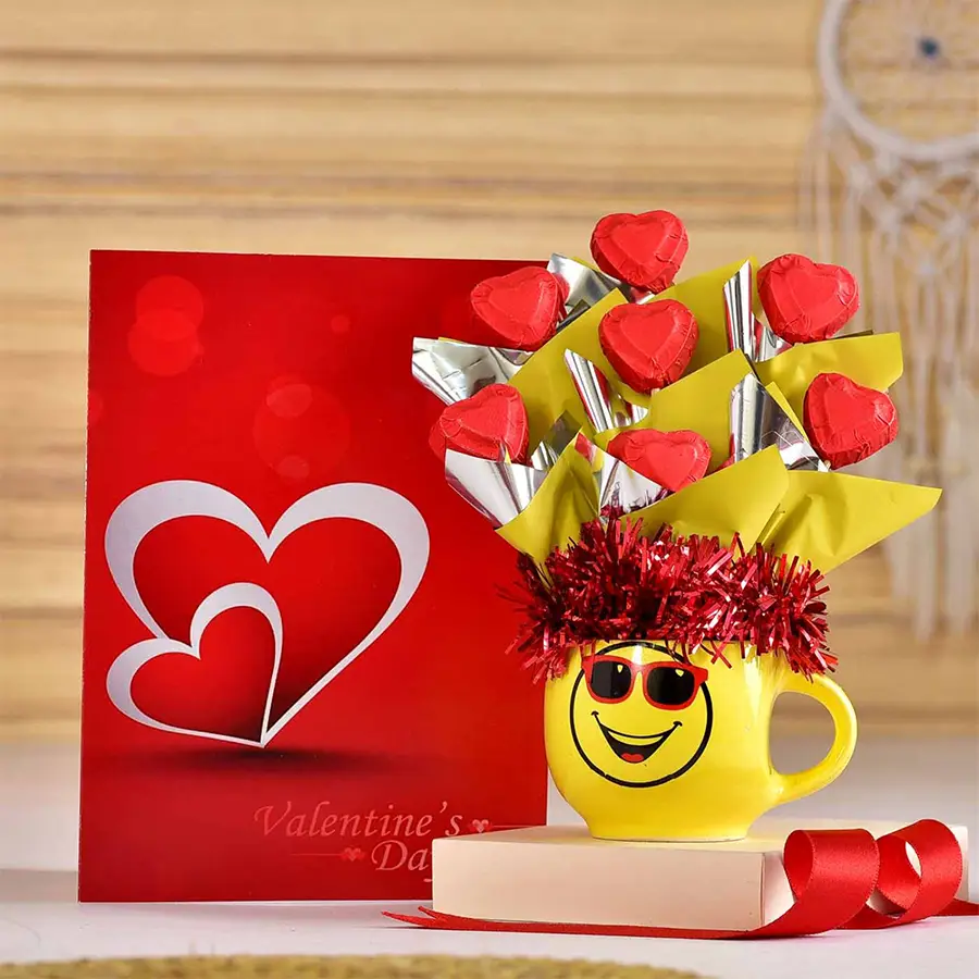 Quirky chocolates pot arrangement with seven homemade chocolates and a Valentine’s card in a smiley pot