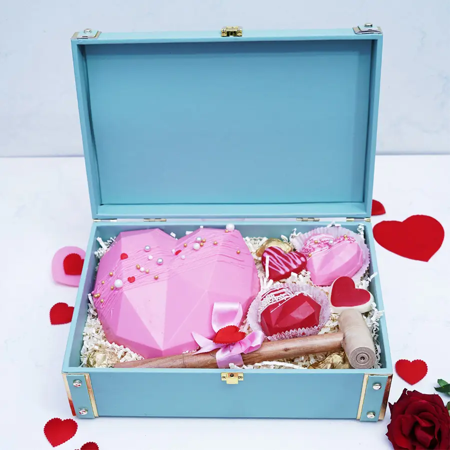 Heartful Choco Delights Gift Box featuring a chocolate pinata, wooden hammer, heart-shaped lollipops, and chocolate almond rocks.