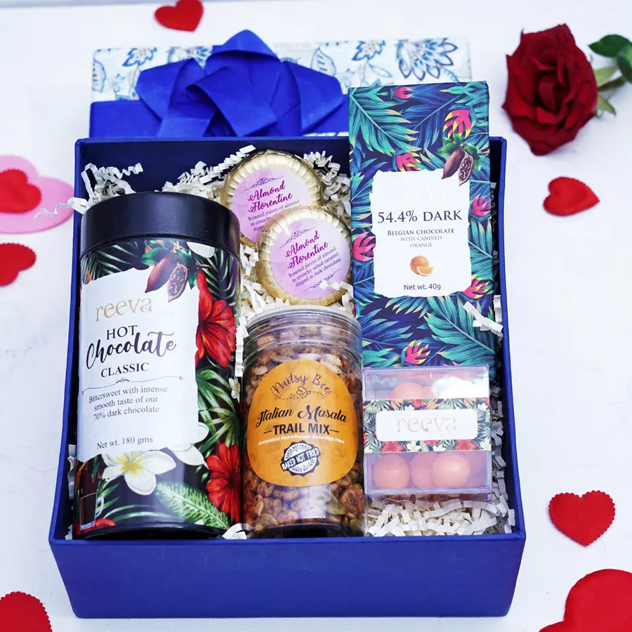 Delightful Chocolate Indulgence Gift Hamper featuring various chocolate treats, including Almond Florentines, Dark Belgian Chocolate, Hot Chocolate, and Orange Marzipan Dragees.