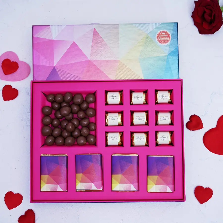 Assorted chocolate box featuring roasted almond, fruit & nut, butterscotch chocolates, zesty orange and dark chocolate bars, and hazelnut dragees.