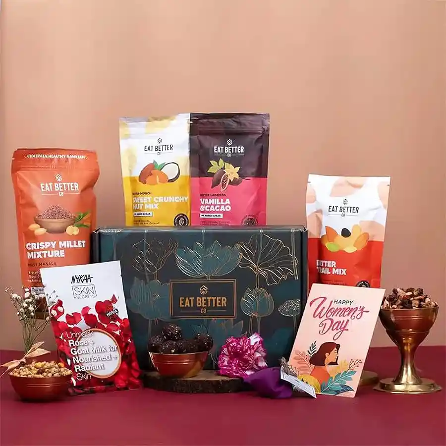 Special Women’s Day Gifts Ensemble featuring Vanilla Chocolate Laddoos, Sweet Crunchy Nut Mix, Chatpata Millet Mix, Better Trail Mix, Nykaa Sheet Mask, Seed Ball, and Women's Day Greeting Card.