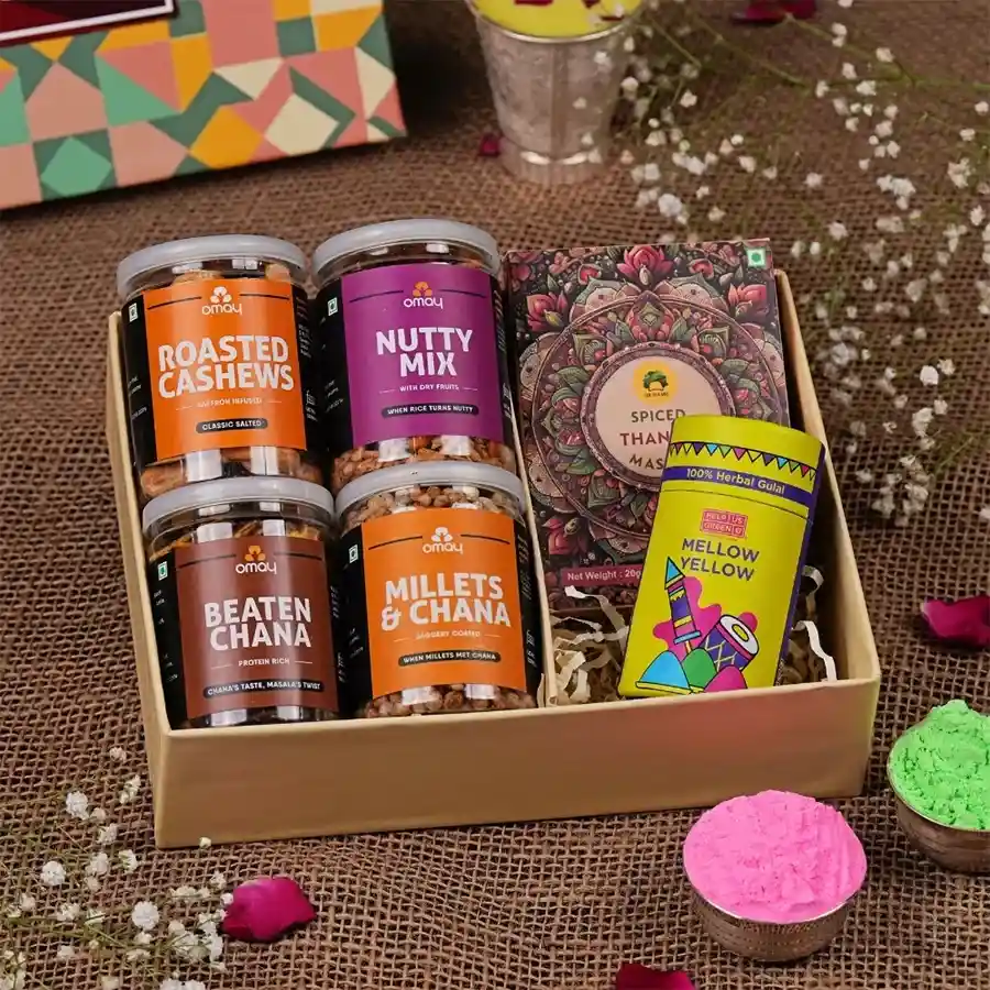 Exclusive Holi Delights Gift Set featuring roasted cashews, beaten chana, nutty mix, millets and chana blend, instant thandai, herbal gulaal, and a Holi greeting card.