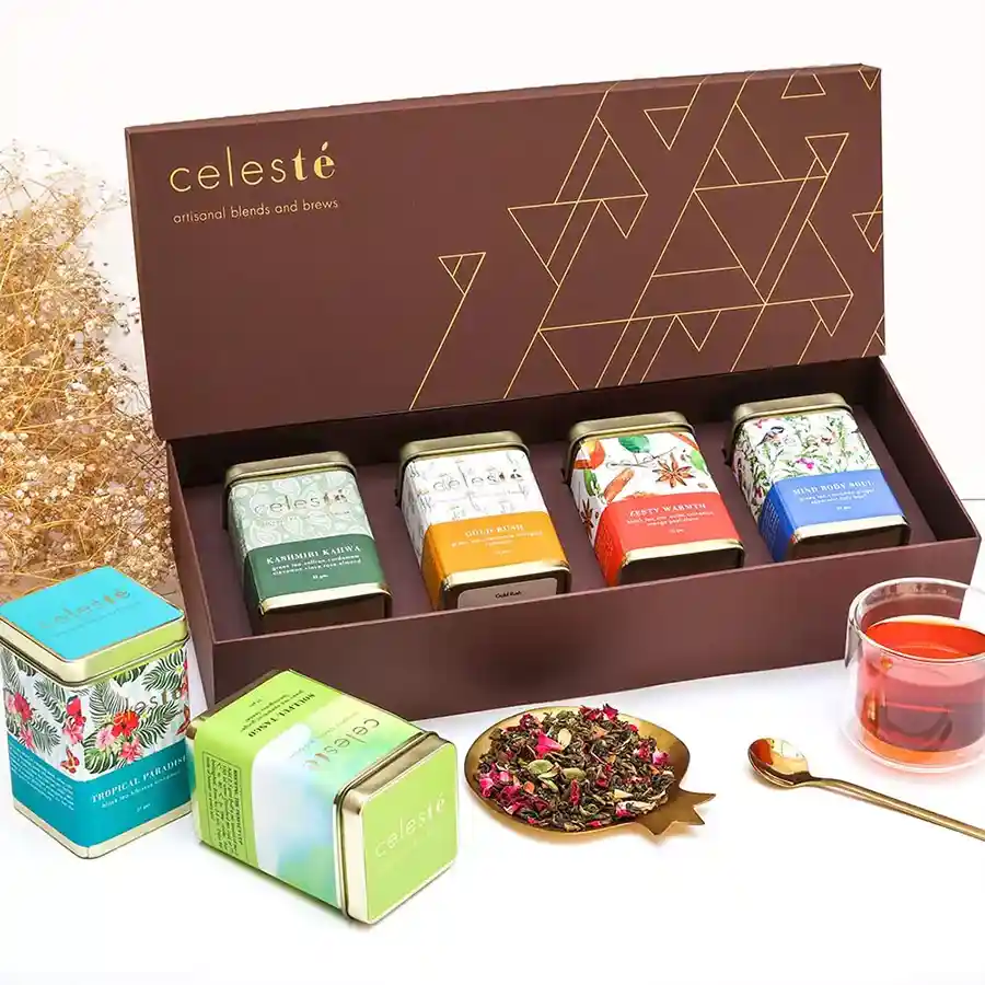Assorted tea gift box with four tin caddies of unique blends displayed elegantly
