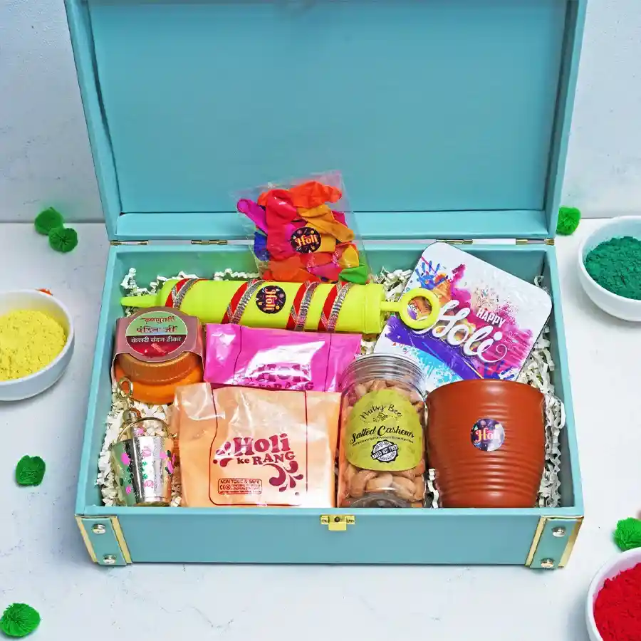 Happy Holi Gifts Delight Hamper featuring colorful Holi powders, balloons, pichkaris, salted cashews in a Kullad cup, Kesari Chandan Tika, Laddu Gopal Balti Pichkari, and a Happy Holi coaster.