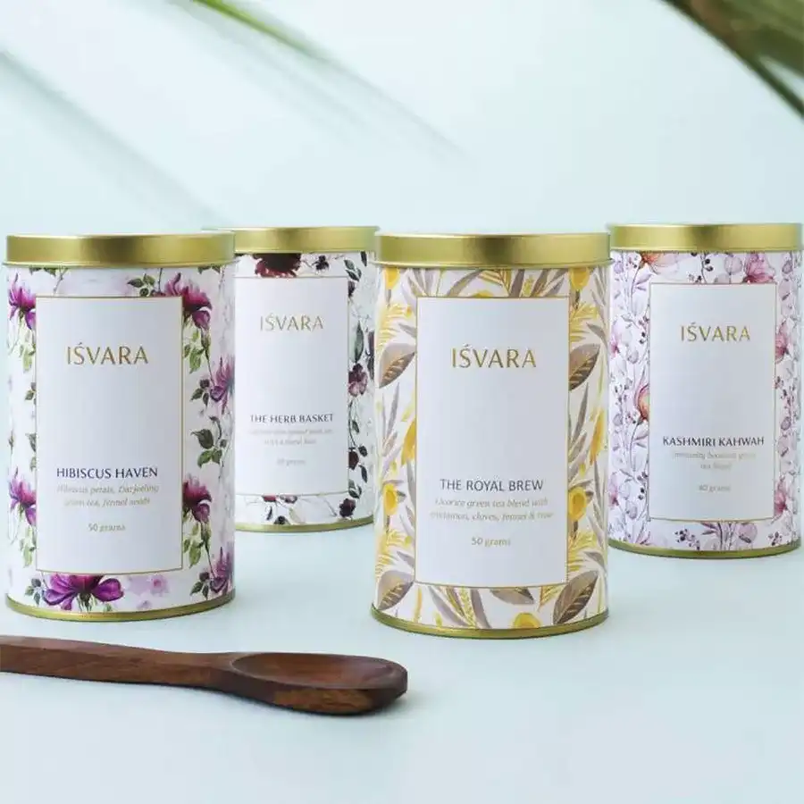 Floral Tea Fusion Gift Set featuring four tea varieties: Hibiscus Green Tea, Floral Pink Tea, Royal Brew Rose Green Tea, and Kashmiri Kahwah Tea arranged in an elegant display.