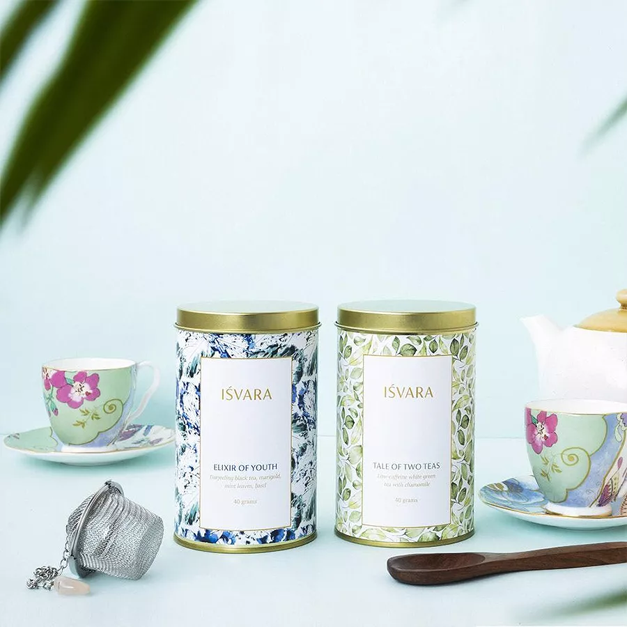 Aromatic Tea Medley Set with Marigold Black Tea and Green & White Tea blend, featuring colorful packaging and tea leaves.