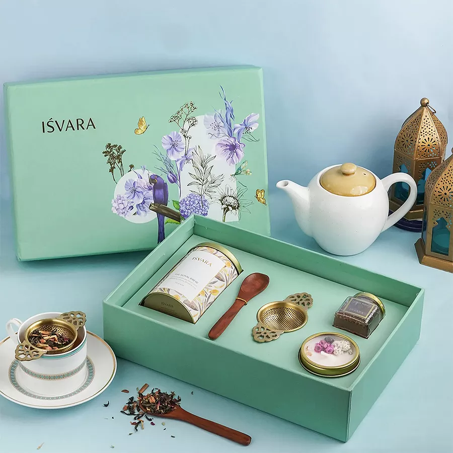 Elegant Tea Gift Set featuring a tea strainer, bamboo candle, honey jar, wooden teaspoon, and keepsake box