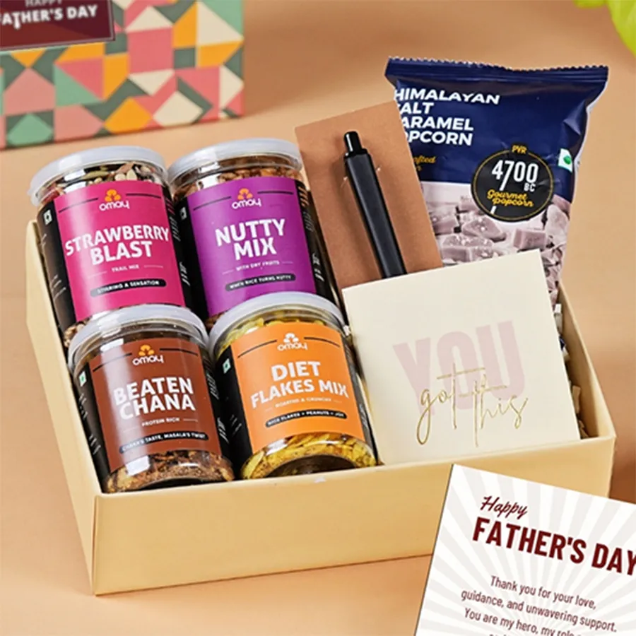 Father's Day gift box featuring assorted snacks and a custom diary, pen, and greeting card.