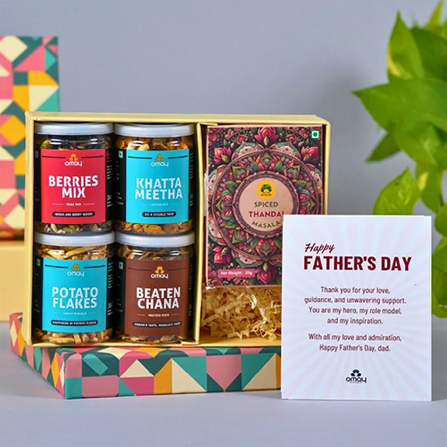 Father's Day Treat Snacks N Thandai Combo from Omay Foods, featuring a variety of savory snacks and a refreshing Gulabs Instant Thandai, along with a Happy Father's Day card.