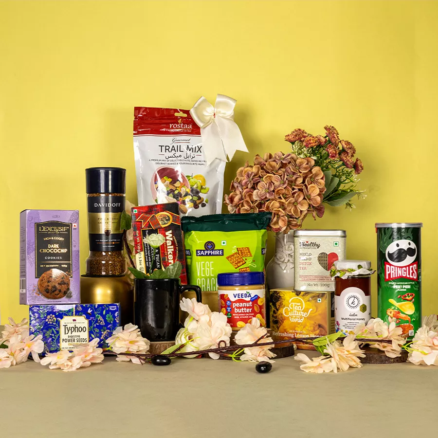 Premium Snacks N Sip Gift Set featuring assorted gourmet snacks, beverages, and a stylish black coffee mug.