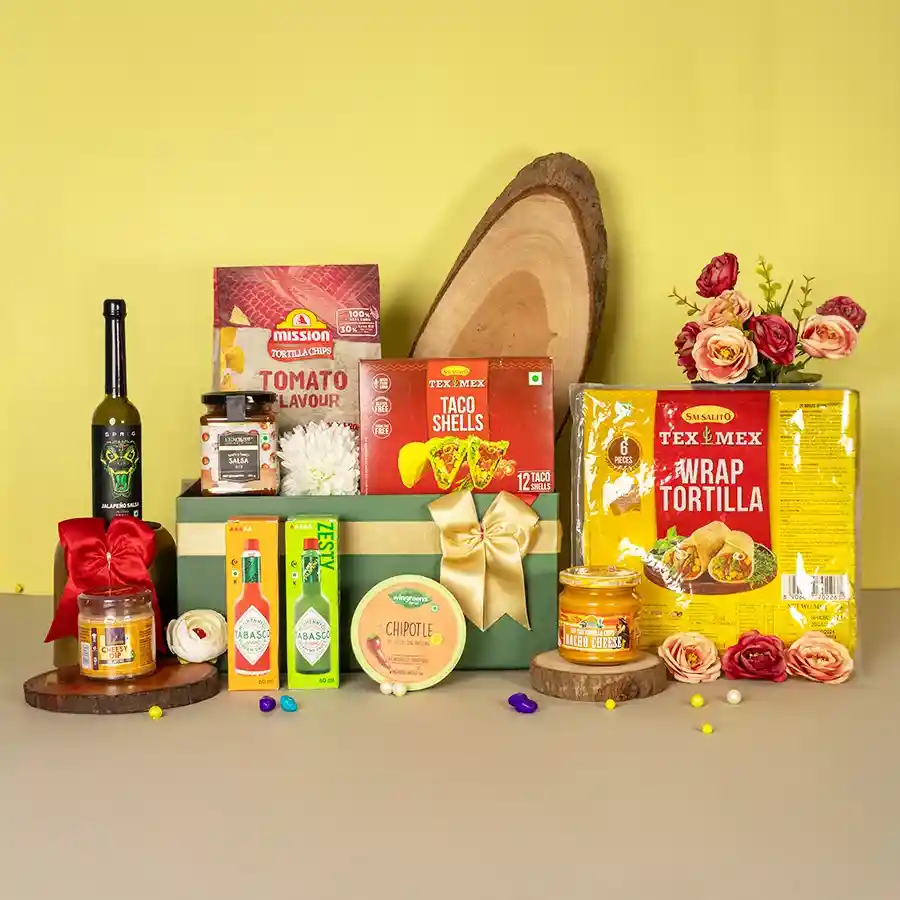 Exquisite Mexican Dip N Chip Gift Hamper with dips, tortilla chips, taco shells, and sauces arranged for a festive presentation