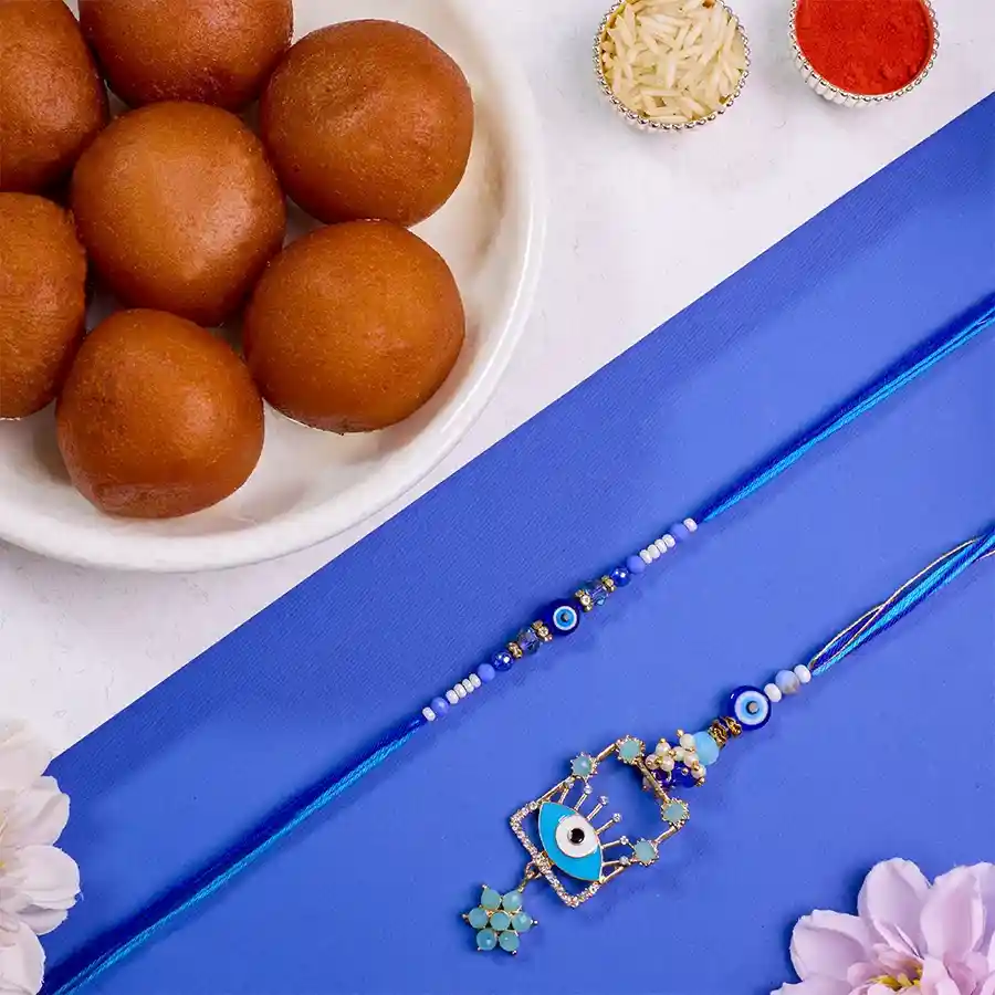 Fancy Evil Eye Bhaiya Bhabhi Rakhi with Gulab Jamun and traditional offerings