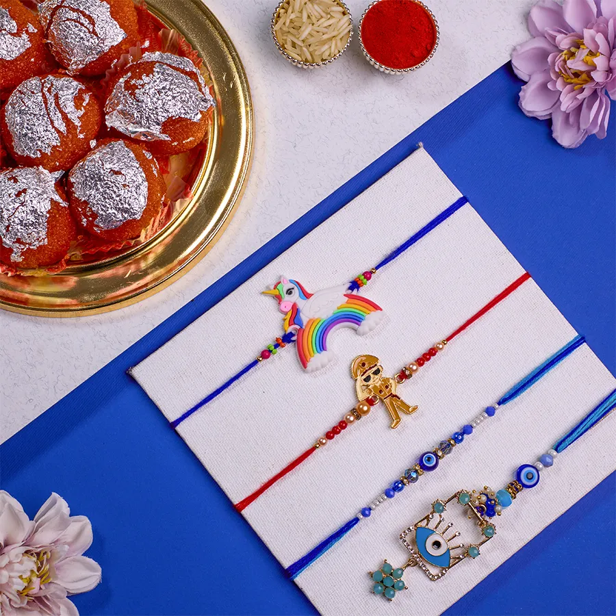 Elegant Family Rakhi Set with Evil Eye Bhaiya Bhabhi Rakhi, Little Singham and Unicorn Rakhis, 500g of Ghee Laddus, and complimentary Roli, Tika, Chawal, and personalized message card.