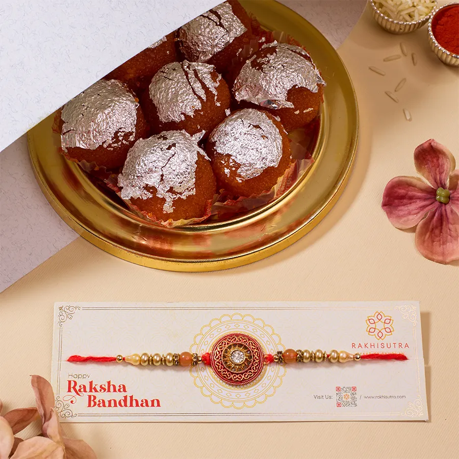 Fancy Kundan Rakhi with Ghee Laddu Combo, including Roli, Tika, Chawal, and a personalized message card.