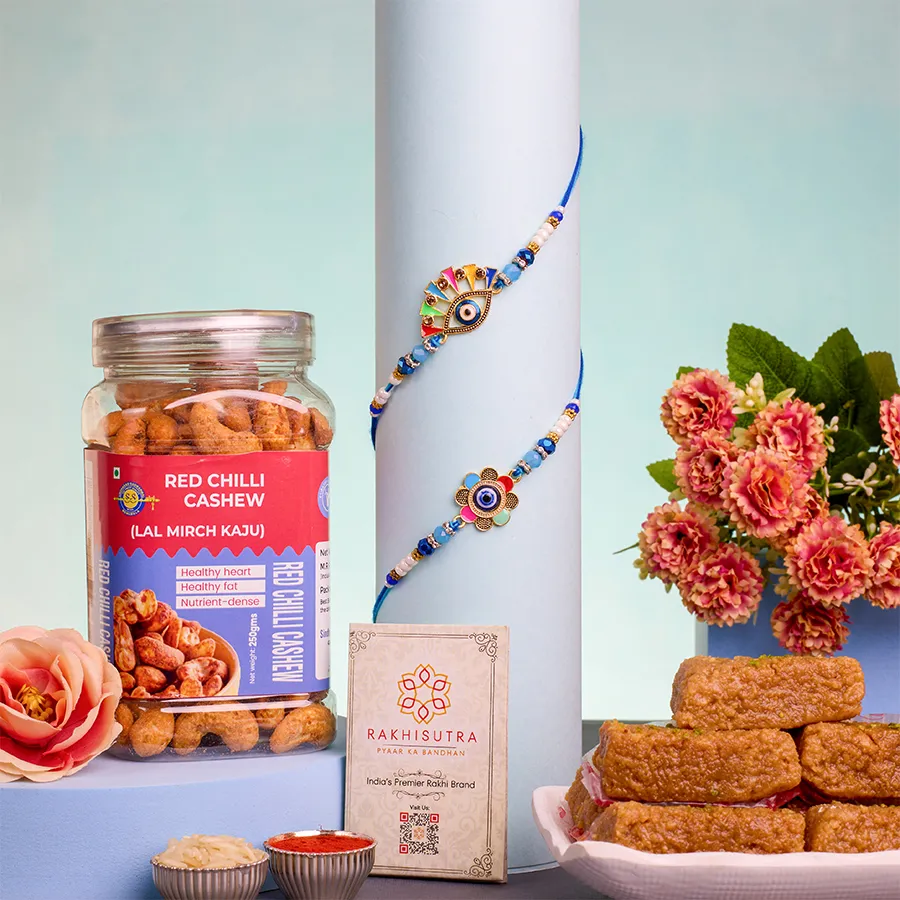 Blissful Evil Eye Rakhi Gift Set featuring two Evil Eye Rakhis, Mini Milk Cake, Red Chilli Cashews, and traditional Roli, Tika, Chawal, and a message card.