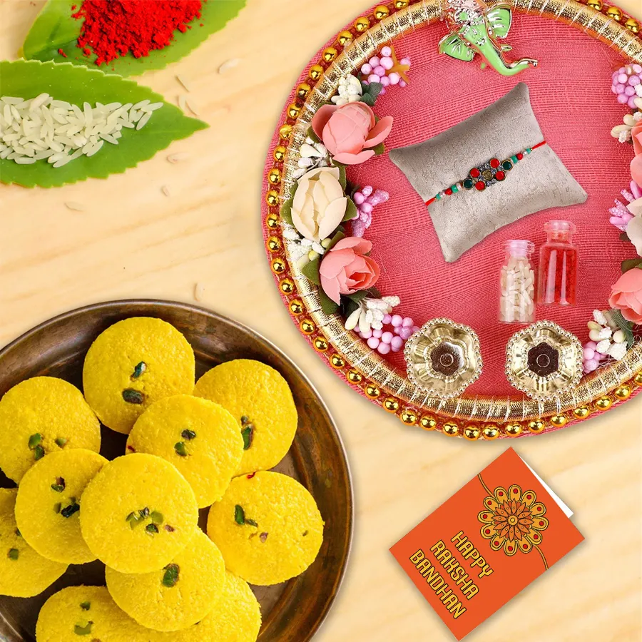 Designer Rakhi Thali with Haldirams Kesaria Peda and a free Rakhi, featuring traditional motifs and vibrant colors.