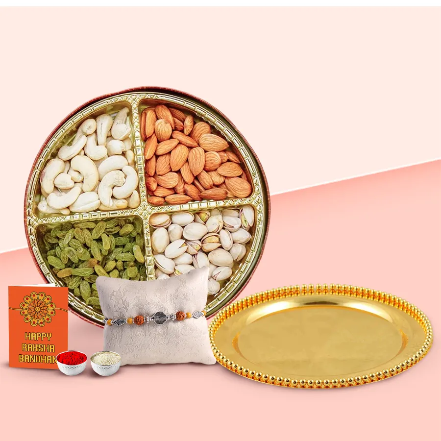 Golden plated rakhi thali with dry fruits, a free rakhi, roli tilak, and chawal set, elegantly presented.