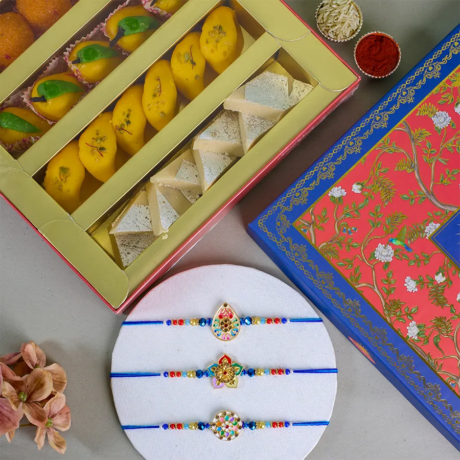 Raksha Bandhan Sweet Delight Box featuring Kundan Rakhis, assorted sweets, roli, tika, chawal, free Rakhi, and personalized message card