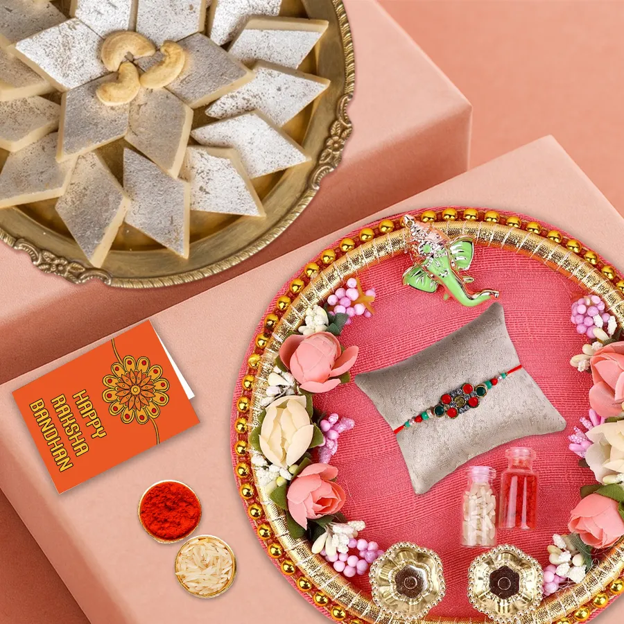 Exotic multicolored rakhi set with decorative rakhi thali, colorful rakhi, and Haldiram Kaju Katli bites arranged for Raksha Bandhan celebration.