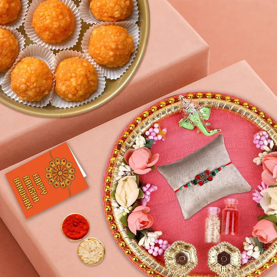 Unique Rakhi Thali with multicolored Rakhi, Roli, Tilak, Chawal, and Haldiram Laddoos