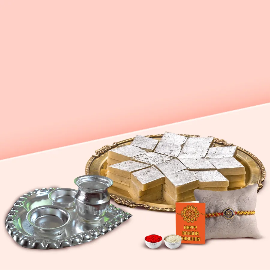 Yummy Sweet Treat hamper for Raksha Bandhan featuring Haldiram’s Kaju Katli, silver-plated puja thali, complimentary Rakhi, Roli, Tilak, and Chawal