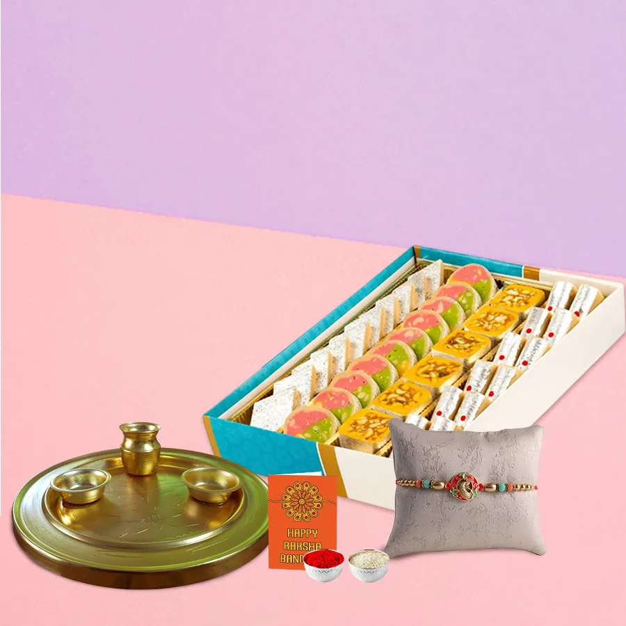 Attractive Rakhi gift set with a beautiful rakhi, Roli Tilak, chawal, 250 grams of Haldiram assorted sweets, and a gold-plated puja thali on a decorative background.