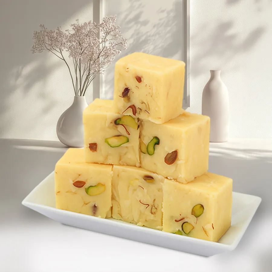A box of Haldiram's Yummy Soan Papdi with a portion of the dessert displayed beside it, showcasing its flaky texture and rich color.