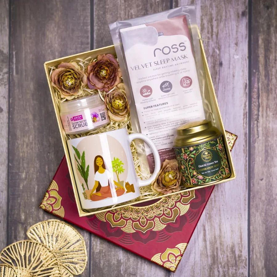 Harmony N Wellness Gift Collection featuring a yoga-themed coffee mug, Glow Secret scrub, Karma Kettle Elachi Green Tea, violet velvet eye mask, and a reusable designer mandala box.