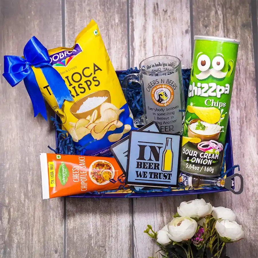 Cheers to Good Times Gift Set featuring a beer mug with a funny quote, two coasters, a bottle opener, Wingreens cheesy chipotle sauce, Chizzpa chips, Dobra tapioca chips, all arranged in a sleek reusable tray.