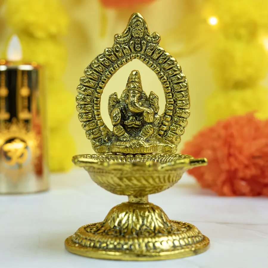 Traditional Brass Ganesha Diya oil lamp showcasing intricate details and warm glow