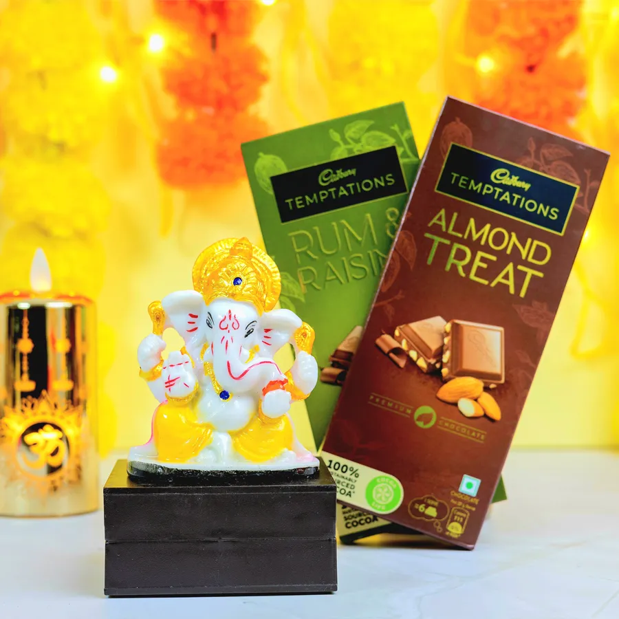 Graceful Mukut Ganesh idol with Cadbury Temptations chocolates in Rum N Raisins and Almond Treat flavors, elegantly packaged for gifting.