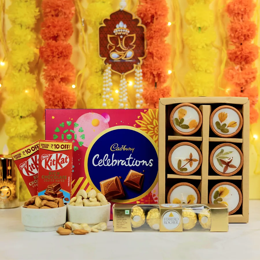 Indulgent chocolates assortment with decorative candles featuring natural dry flowers in an elegant setting
