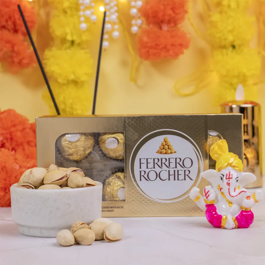 Auspicious Ganesha idol with Ferrero Rocher chocolates and pista nuts in a decorative setting
