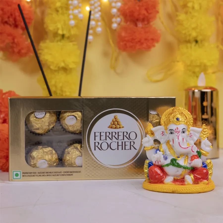 Graceful Ganesha statue in Abhaya Mudra next to a box of Ferrero Rocher chocolates