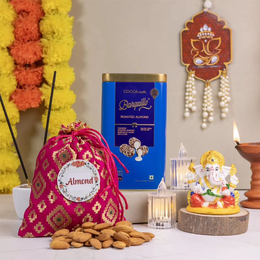 Luxe Diwali Celebration Gift Set featuring a Marble Abhaya Mudra Ganesha, 100g Almond Potli, 200g Barquillo Roasted Almond Coated Chocolate, and two elegant LED tea lights arranged beautifully.