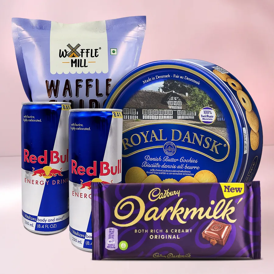 Sparkling Cookie Combo featuring Red Bull cans, Royal Dansk Danish Butter Cookies, Cadbury Dark Milk Chocolate Bar, and Waffle Mills Chocochip Waffles arranged festively for Christmas.