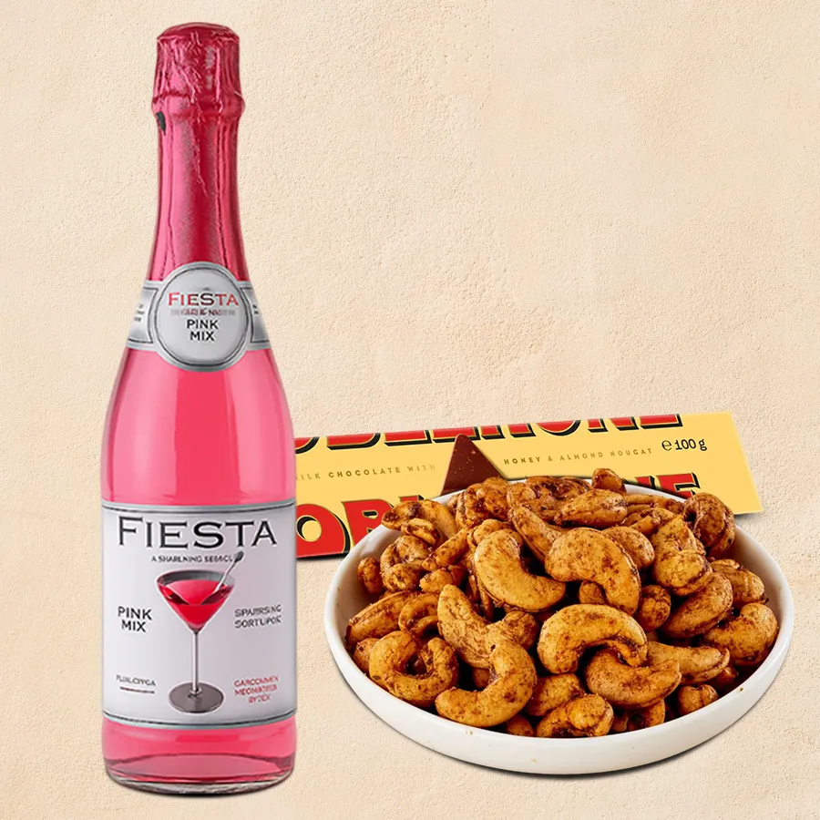 Exotic Treats Christmas Hamper featuring Masala Cashews, Fiesta Juice Bottle, and Toblerone chocolate bar